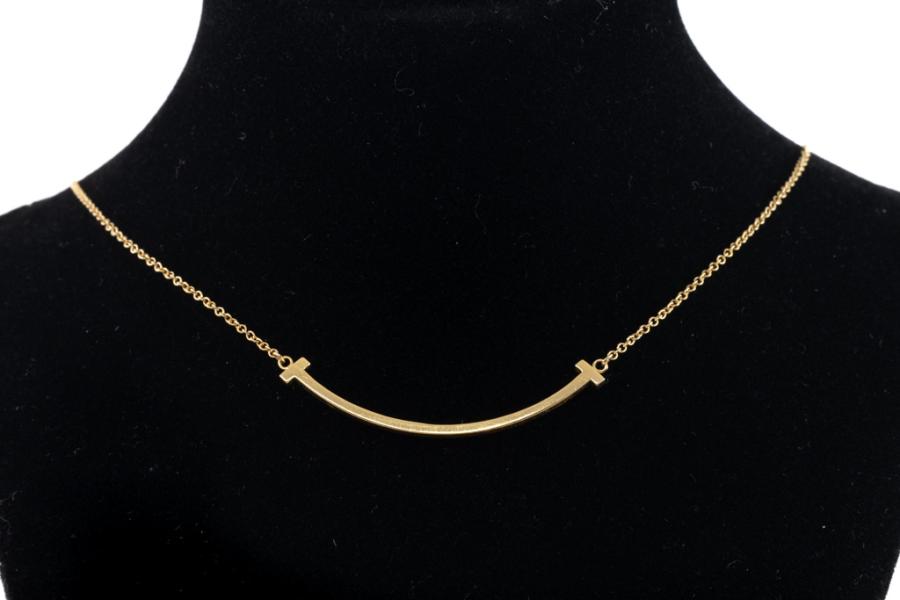 Tiffany T pendant in 18k gold with a baguette diamond. | Tiffany & Co.
